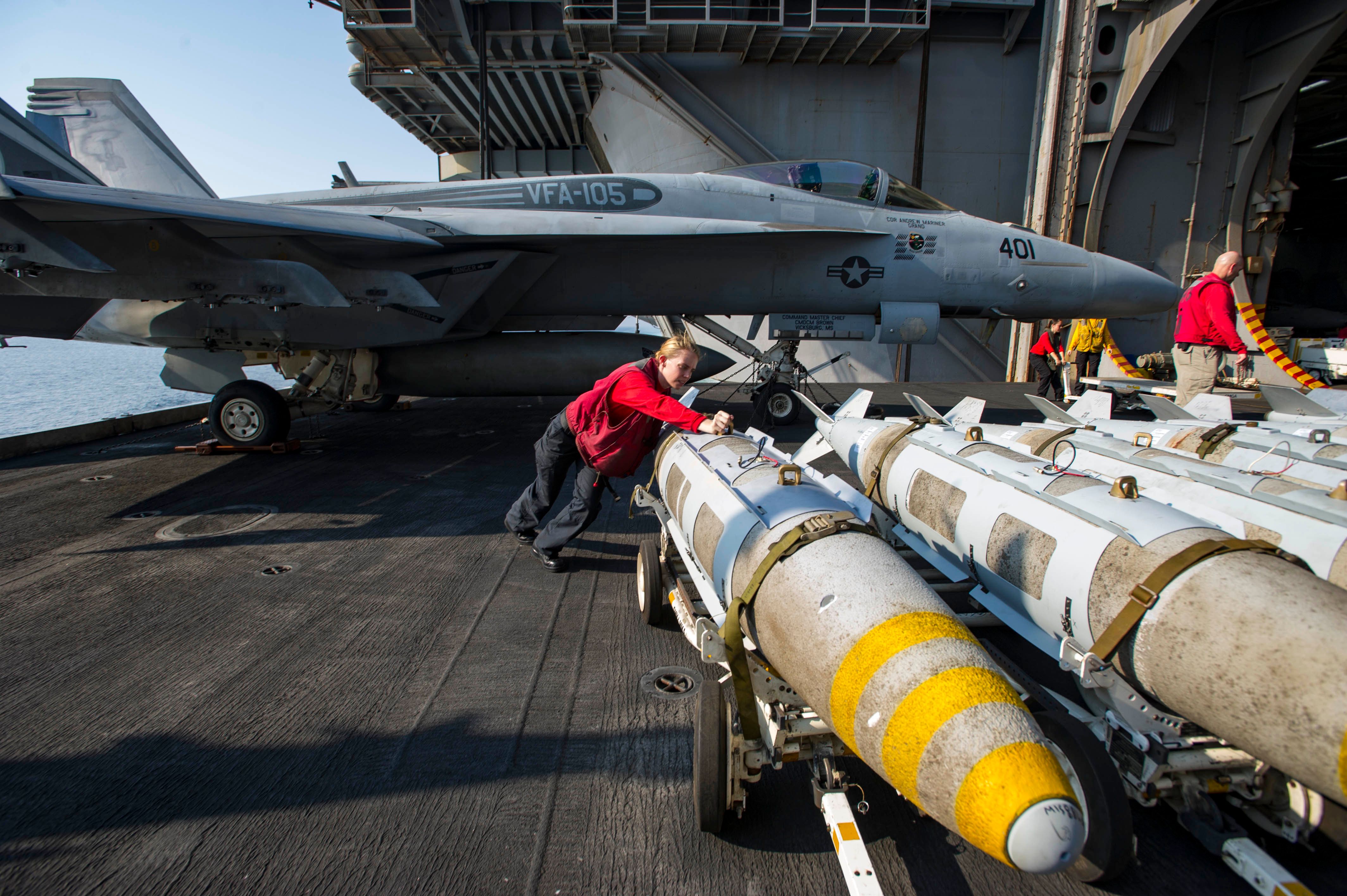 161027-N-WS581-348 ARABIAN GULF (Oct. 27, 2016) Petty Officer 3rd Class Ashley Wilson, from Macon, Mo., pushes a GBU31 bomb onto an aircraft elevator aboard the aircraft carrier USS Dwight D. Eisenhower (CVN 69) (Ike). Wilson serves aboard Ike as an aviation ordnanceman and is responsible for assembling and maintaining ordnance for the ship. Ike and its Carrier Strike Group are deployed in support of Operation Inherent Resolve, maritime security operations and theater security cooperation efforts in the U.S. 5th Fleet area of operations. (U.S. Navy photo by Petty Officer 3rd Class Andrew J. Sneeringer)