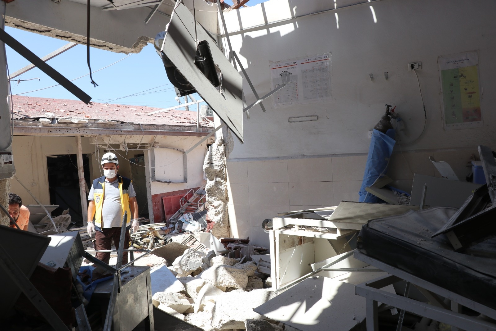An image of a White Helmet searching through the rubble of the hospital following airstrikes on Afrin on June 12, 2021. (Image posted by Syrian Civil Defense)