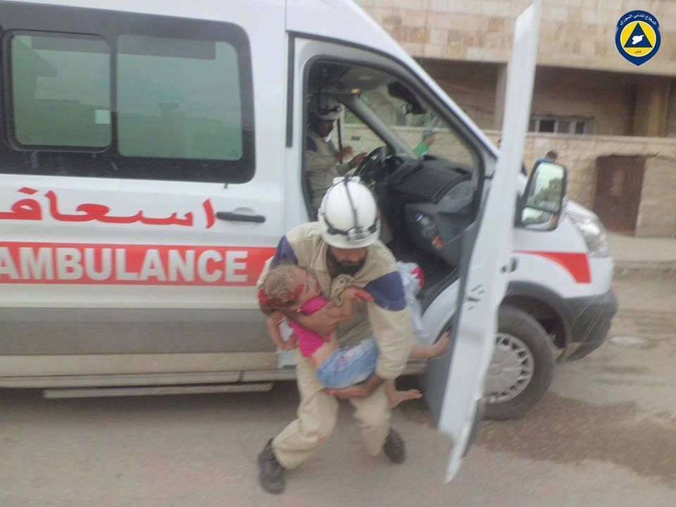 A 'White Helmet' rushes child victim of a likely Russian aircraft to casualty, October 8th 2015 (via SNN)