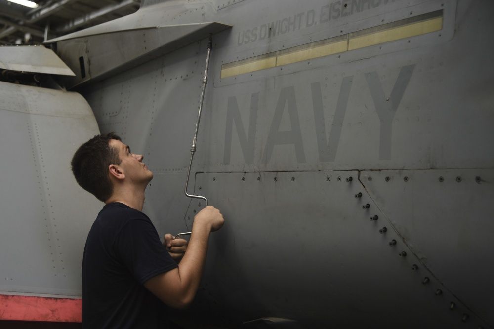 Aviation Structural Mechanic Airman Zachary Potts, from Hickory, N.C., conducts maintenance on the trailing edge flat fairing panel of an F/A-18E Super Hornet assigned to the Sidewinders of Strike Fighter Squadron (VFA) 86 in the hangar bay of the aircraft carrier USS Dwight D. Eisenhower (US Navy)