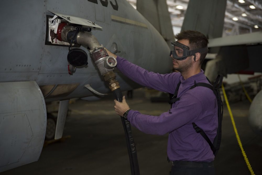 The internal tank of an F/A-18E Super Hornet is defueled in the hangar bay of the aircraft carrier USS Dwight D. Eisenhower, Oct 3rd (US Navy)