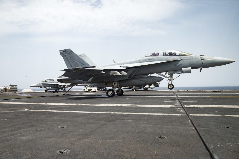 n F/A-18F Super Hornet assigned to the Fighting Swordsmen of Strike Fighter Squadron (VFA) 32 makes an arrested landing on the flight deck of the aircraft carrier USS Dwight D. Eisenhower (US Navy)
