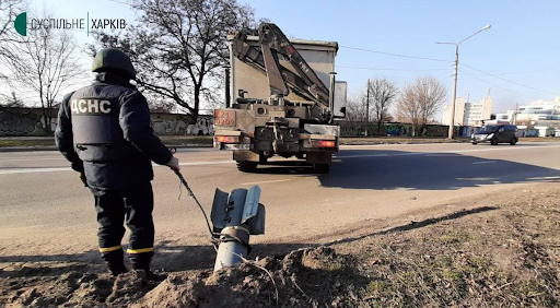 Image showing what looks to be a rocket embedded in the road following Russian shelling of Kharkiv on March 24, 2022. (Image posted by @eoin_mc_sweeney)