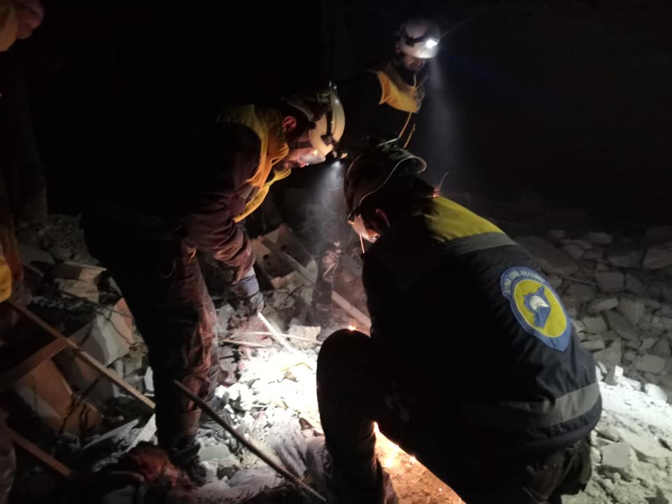 Syrian Civil Defence volunteers looking for victims and survivors underneath the rubble after alleged Russian airstrikes on the village of Arinba on January 23rd, 2020 (via SCD).
