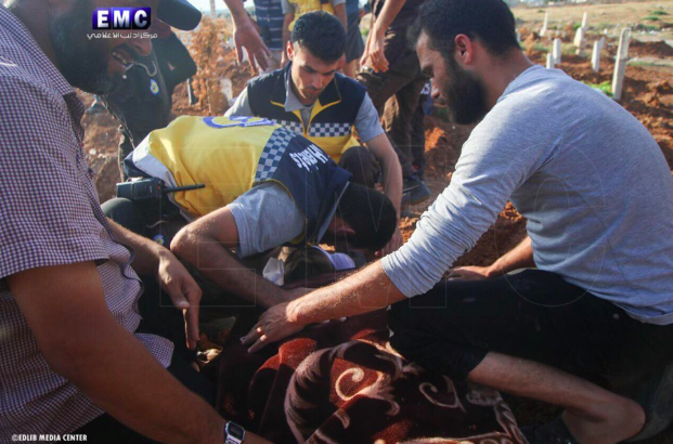 Syrian Civil Defense teams at the funeral of two of their colleagues who were killed in an alleged Russian double-tab airstrike on Khan Sheikhoun on June 26th (via Edlib Media Center).