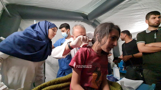 Image of a child being treated for injuries from strikes on Al Jeniya neighborhood on May 13, 2021. (Image posted by Paltoday News)