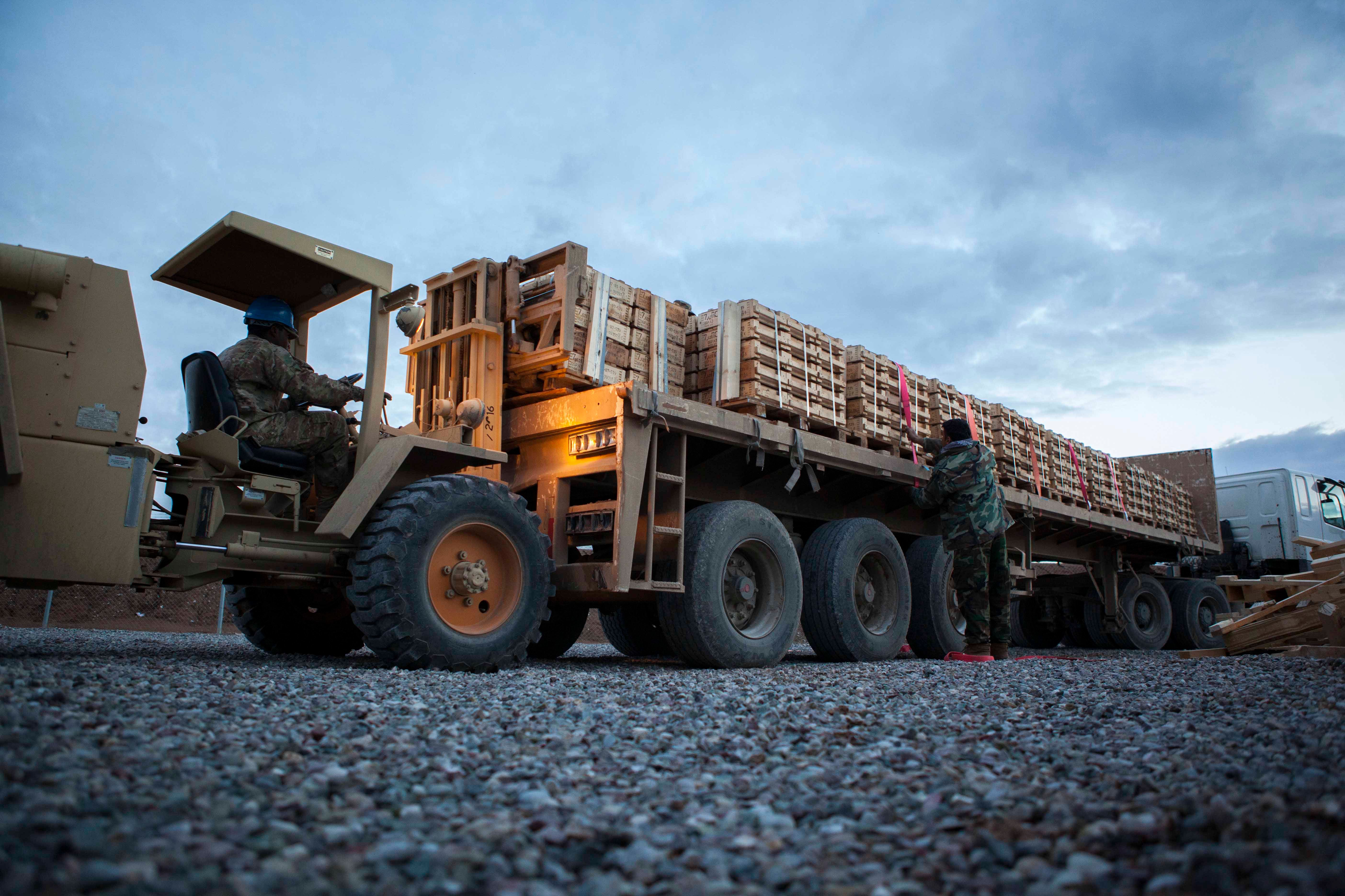 U.S. Army Sgt. Kendall Smalls, with the 119th Inland Cargo Transfer Company, 1st Infantry Division Sustainment Brigade, loads crates of ammunition to a flatbed truck near Erbil, Iraq, Jan. 3, 2016. More than 5 million rounds of small arms ammunition were donated to the Peshmerga to aid in the fight against the Islamic State of Iraq and the Levant (ISIL). Sixty-five coalition partners have committed themselves to the goals of eliminating the threat posed by ISIL and have contributed in various capacities to the effort to combat the terrorist organization in Iraq, the region and beyond. (U.S. Army photo by Staff Sgt. Sergio Rangel/Released)