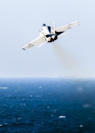  An F/A-18E Super Hornet, assigned to the “Pukin’ Dogs” of Strike Fighter Squadron (VFA) 143, launches from the flight deck of aircraft carrier USS Harry S. Truman (CVN 75). Harry S. Truman Carrier Strike Group is deployed in support of Operation Inherent Resolve.