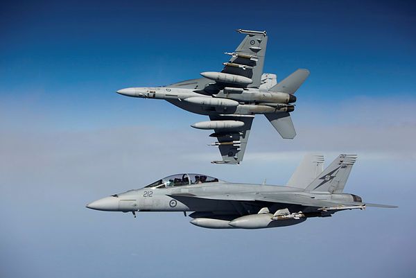 A Royal Australian Air Force F/A-18F Super Hornet peels away from another en-route from the Middle East to Iraq. (Aus MoD)
