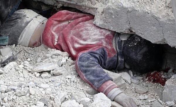 The body of a child stuck under rubble following an alleged Russian raid on Salheen, February 8th (via SN4HR)