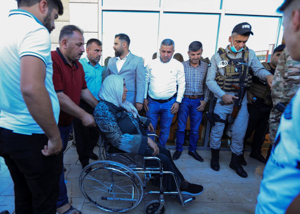 A man pushes a wheelchair carrying a woman wounded by a Turkish attack, next to a hospital in Zakho, Iraq, July 20, 2022. REUTERS/Ari Jalal