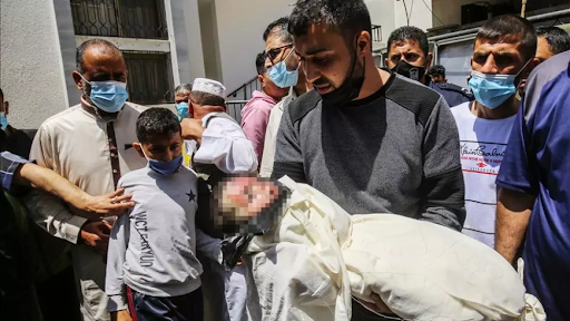 Graphic image of a child allegedly killed in strikes on Al Jeniya neighborhood on May 13, 2021. (Image posted by Alaraby News)