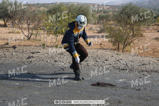 A White Helmet with remnants from the drone attack on the Ariha Al-Mastouma road on December 3, 2021. (Image posted by Macro Media Center)