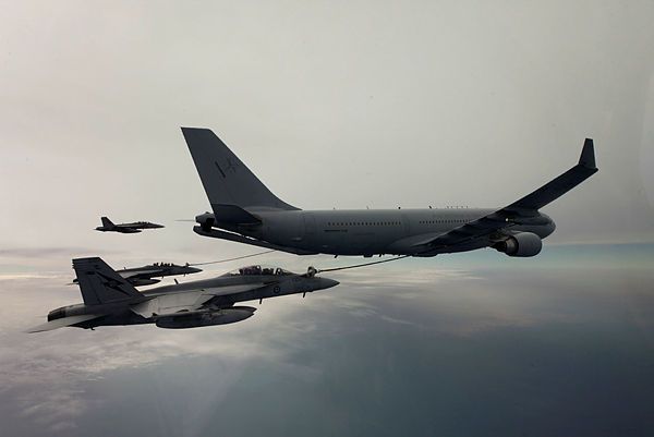 A Royal Australian Air Force (RAAF) KC-30A Multi-Role Tanker Transport conducts refuelling operations with three RAAF F/A-18F Super Hornets above heavy cloud in the Middle East Region (Aus MoD)