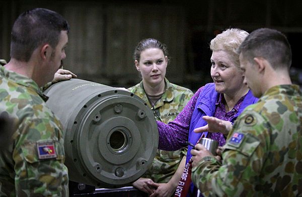 Parliamentarian, Ann Sudmalis, MP, speaks with Air Force Armament Technicians as they construct a Guided Bomb Unit-31 (GBU-31) for use by the Australian Air Task Group in the Middle East Region.