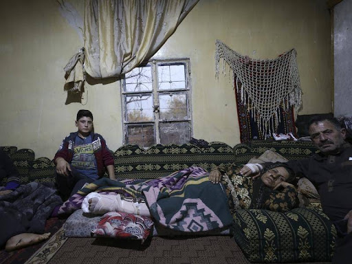 The Qasoum family, injured by a US strike in Idlib December 3rd 2021. Image via Associated Press.