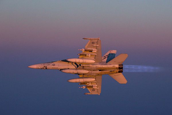 A Royal Australian Air Force F/A-18F Super Hornet ignites its afterburners at dusk over Iraq. (Aus MoD)
