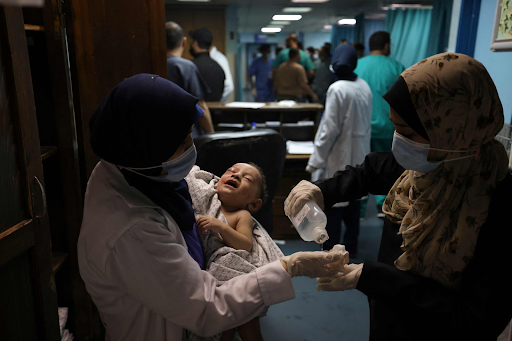 Image of baby Omar Al Hadidi, pulled from the rubble in critical condition and bring treated in a hospital following strikes on Al Shati camp on May 15th, 2021. (Image posted by @alqudsnewspaper)