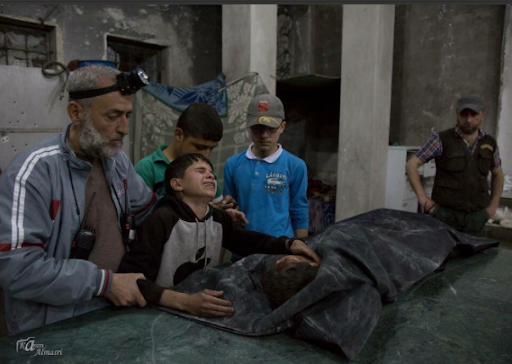 Civilians mourning in the aftermath of the aerial strikes at al-Quds Hospital in al-Sukkari, Aleppo