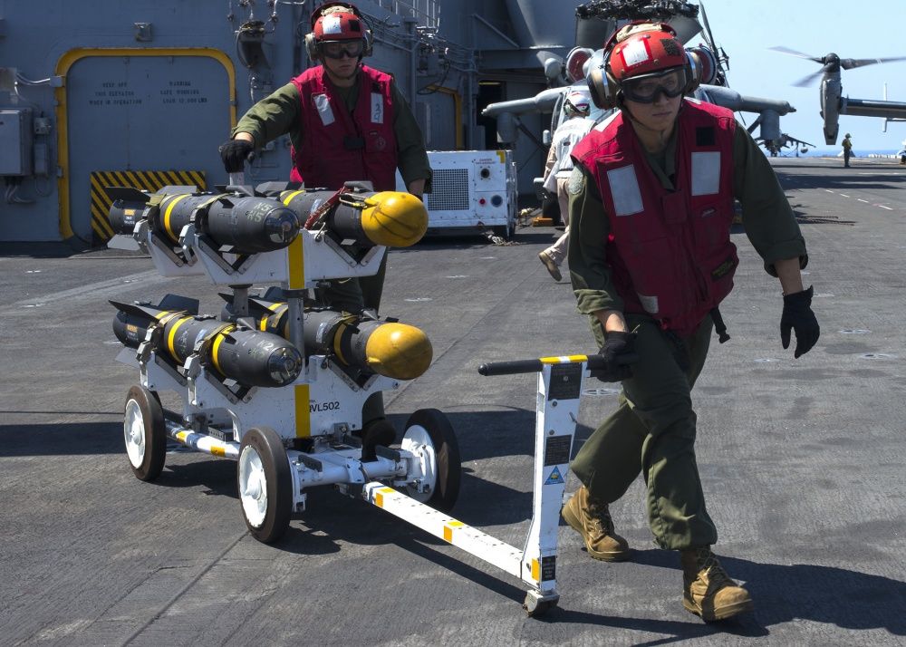 Marines transport AGM-114 Hellfire missiles across the flight deck aboard the amphibious assault ship USS Wasp (US Navy)