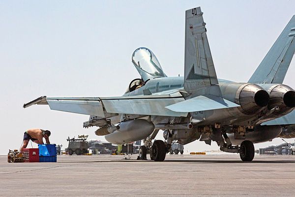 An Air Task Group Strike Element member conducts maintenance on a Royal Australian Air Force F/A-18A Hornet (Aus MoD)