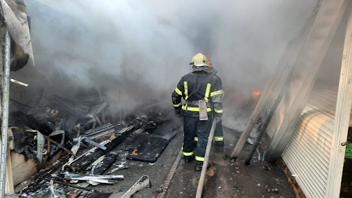 Rescue workers put out a fire at the market in the Heroiv Pratsi on March 16, 2022. (Image posted by DSNS via Telegram)