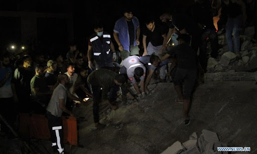 Palestinians gather as rescuers search for victims at the site of a house destroyed by Israeli airstrikes at the Shati refugee camp in Gaza City, May 15, 2021.Photo:Xinhua