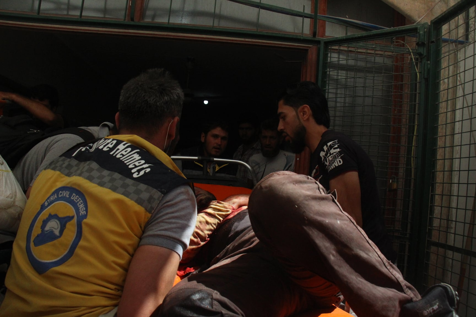 Civil Defense members treat the injured following a double strike on Sarja on July 17, 2021. (Image posted by Syrian Civil Defense)