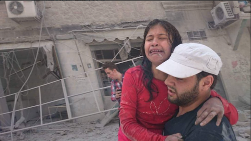 Civilians in the aftermath of the aerial strikes at al-Quds Hospital in al-Sukkari, Aleppo