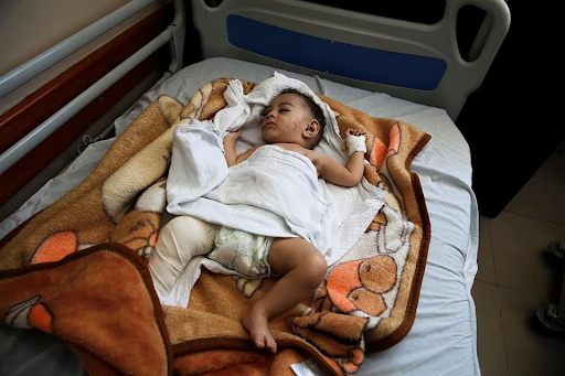 Image of baby Omar Al Hadidi, pulled from the rubble in critical condition and bring treated in a hospital following strikes on Al Shati camp on May 15th, 2021. (Image posted by Paltimes2015 via Facebook)