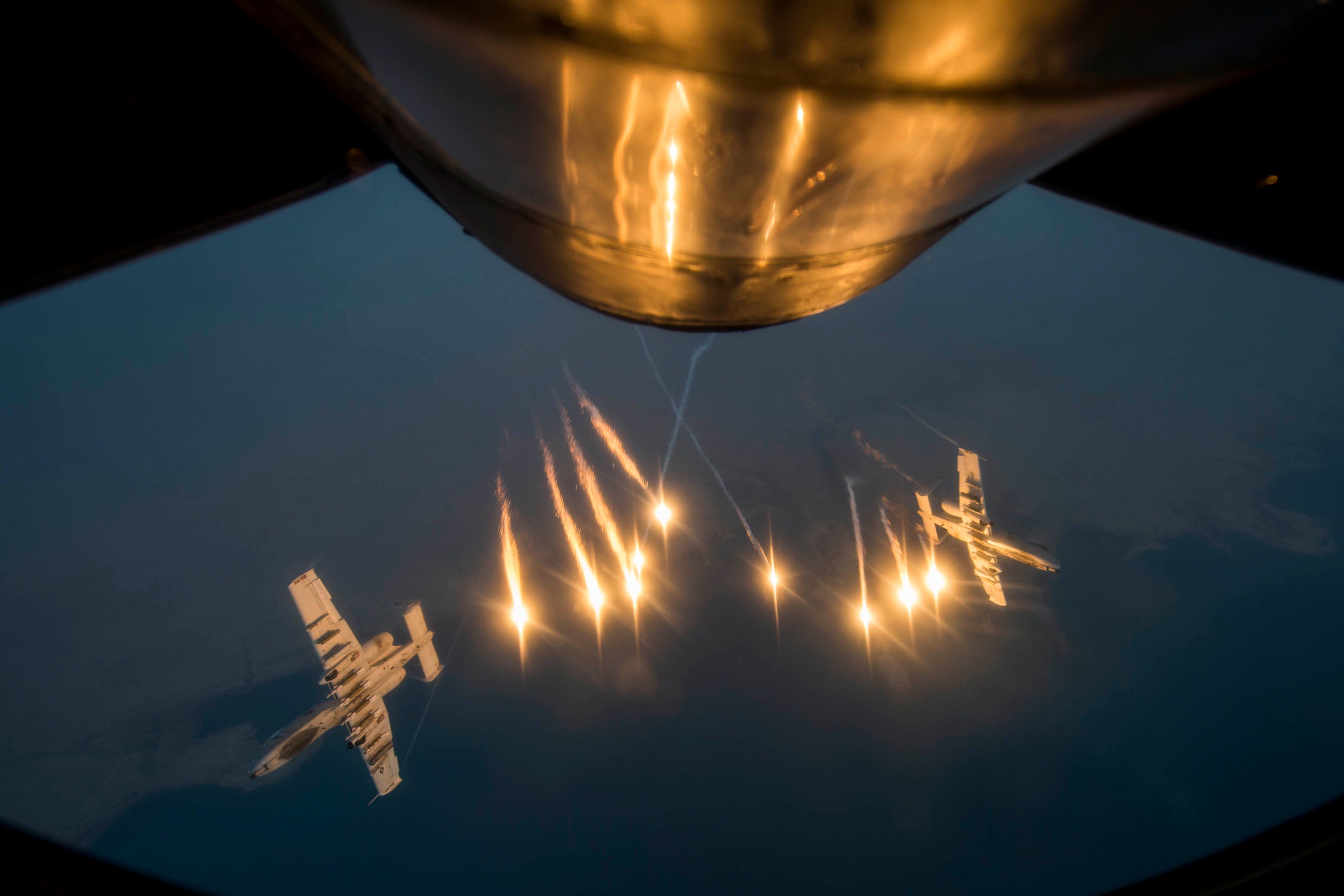 Two US A-10 release flares after receiving fuel from a KC-135 Stratotanke "over Southwest Asia," Oct. 13th 2015. (USAF/ Senior Airman Taylor Queen)