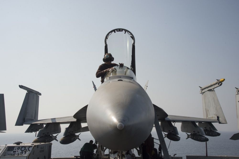 The canopy of anopy of an F/A-18E Super Hornet is cleaned aboard the flight deck of the aircraft carrier USS Dwight D. Eisenhower (US Navy)