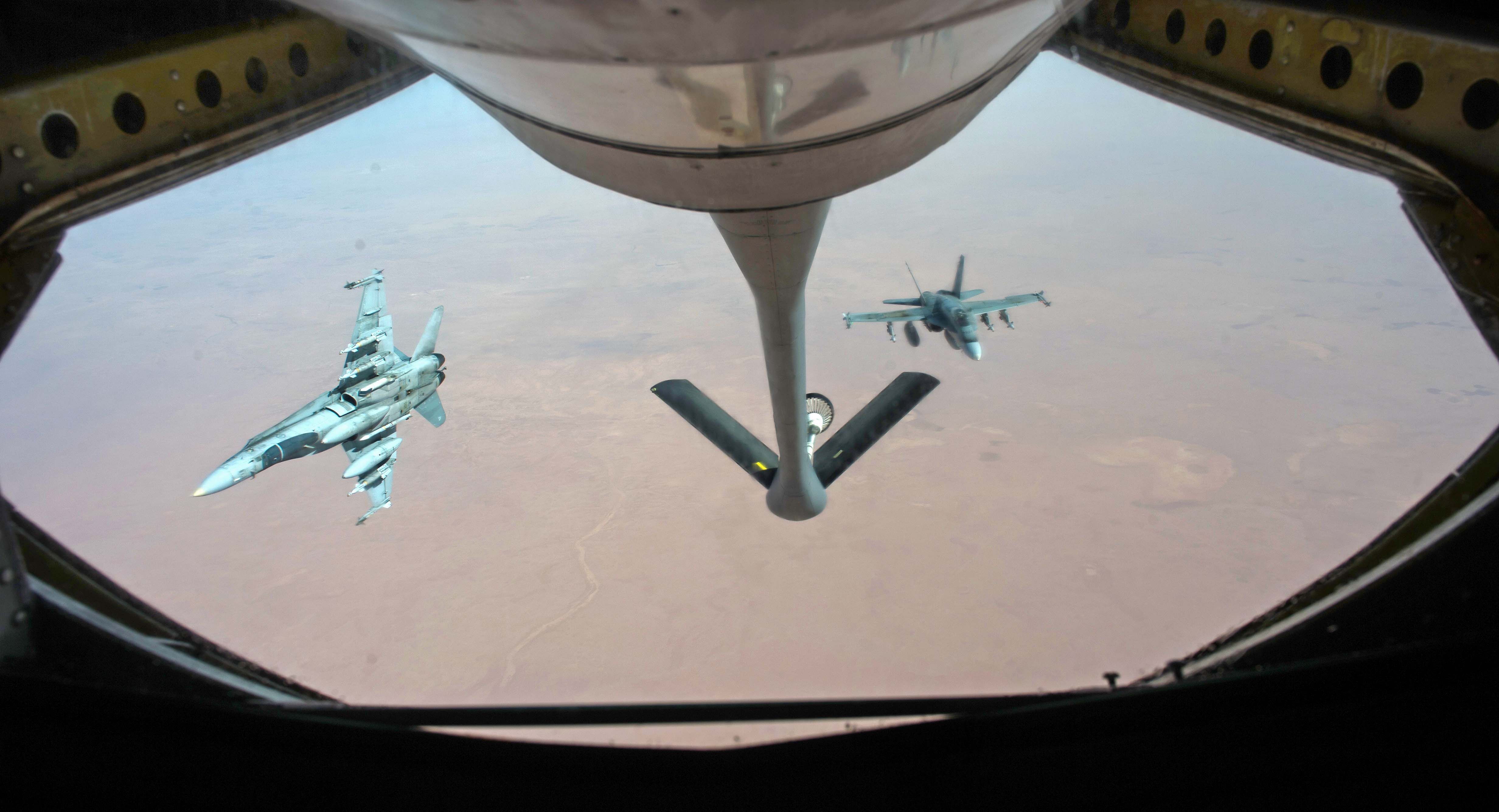 Canadian CF-18 Hornets break away after refueling with a US tanker Nov 1st 2014 ( USAF/SSgt. Perry Aston)