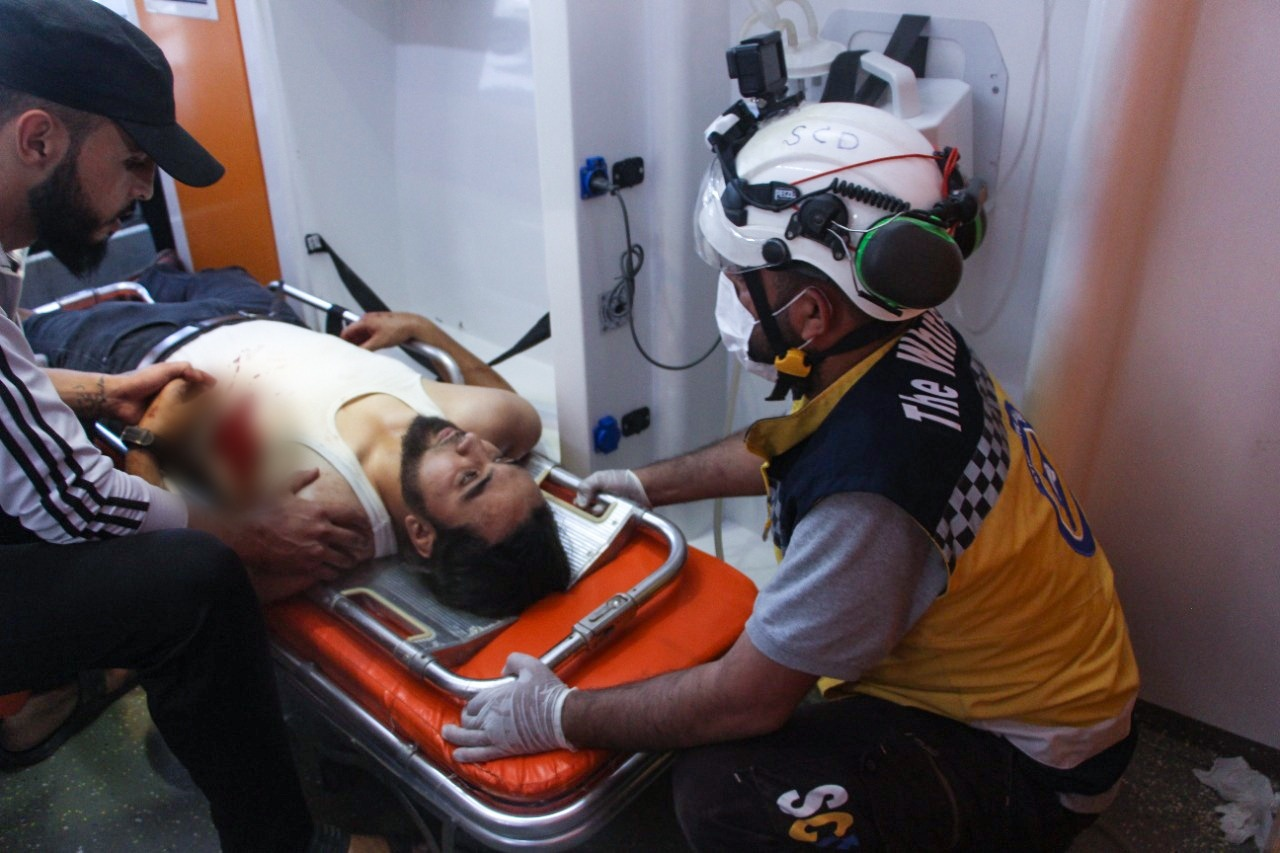 A member of the Syrian Civil Defense helping an injured victim following the airstrikes on Afrin on June 12, 2021. (Image posted by Syrian Civil Defense)