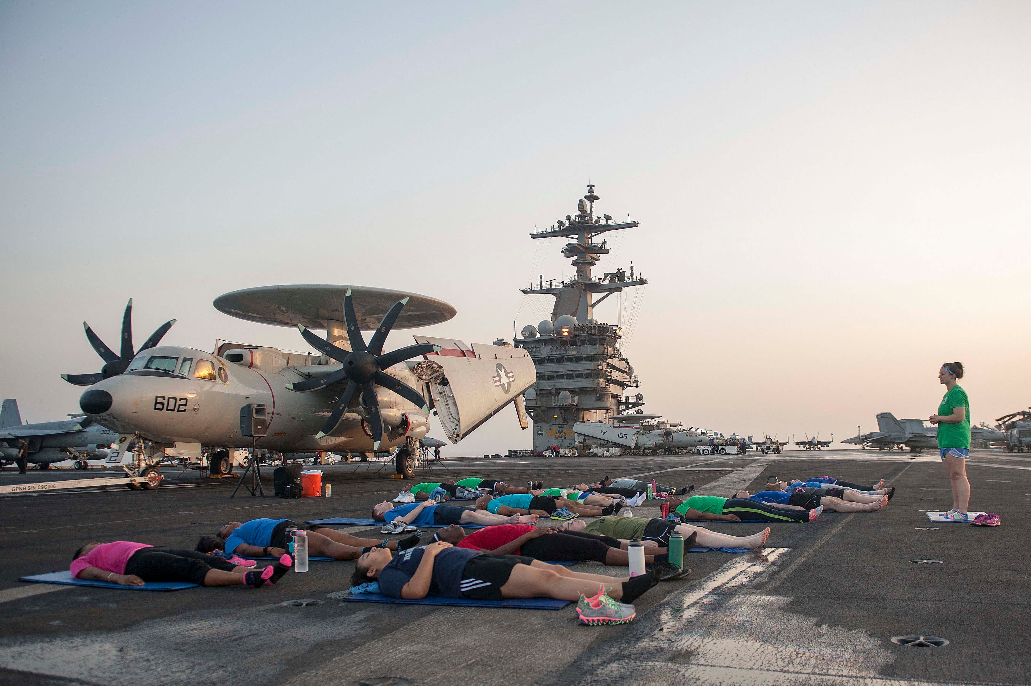 Sunrise yoga class on USS Theodore Roosevelt, September 2015 (US Navy/ Chris Liaghat)