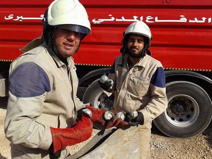 Two members of The White Helmets holding the remnants of the cluster munitions shells, following an alleged Russian raid on, November 7th (via SNHR)