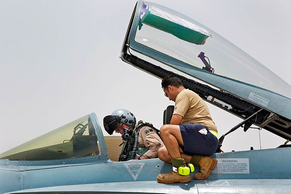 Commander Air Task Group, Air Commodore Philip Gordon, straps in to an F/A-18A Hornet prior to departing on a mission out of Australia's main air operating base in the Middle East region. (Aus MoD)