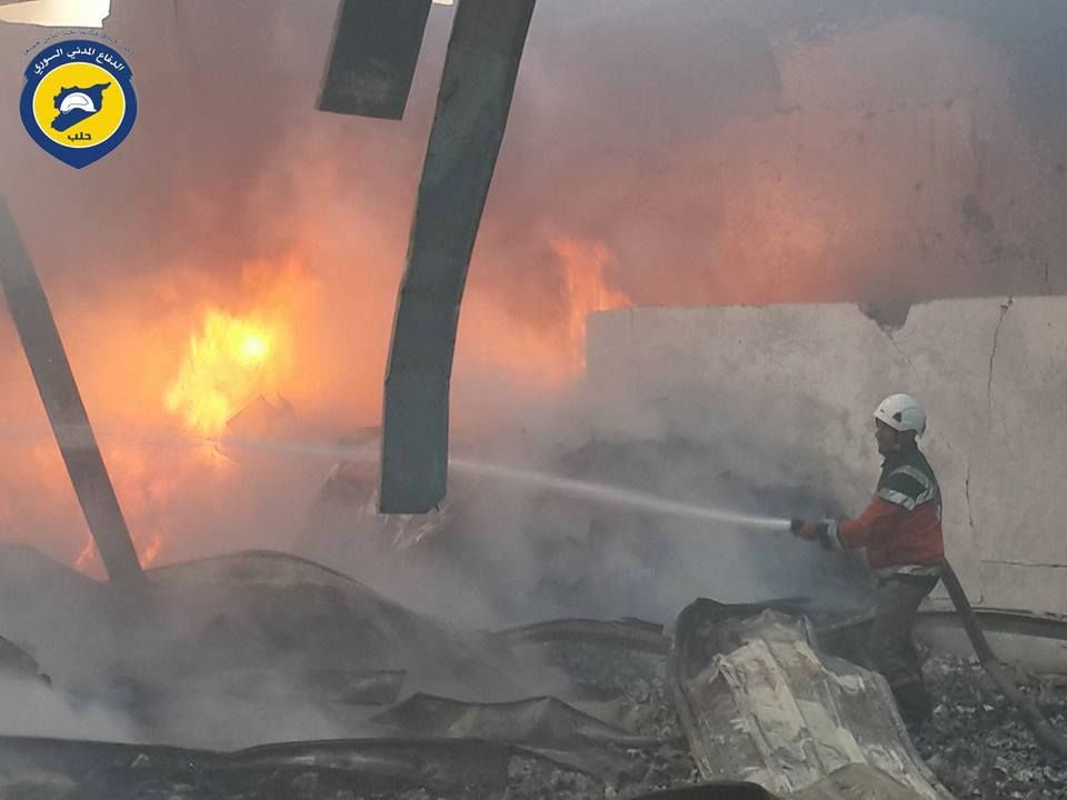 A member of the White Helmets attempts to put out a fire in the aftermath of an alleged Russian airstrike on the Al Dairi fabrics factory, Aleppo, Nov 7th (via White Helmets)