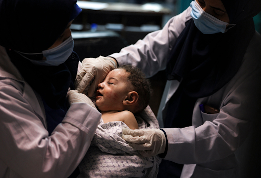 Image of baby Omar Al Hadidi, pulled from the rubble in critical condition and bring treated in a hospital following strikes on Al Shati camp on May 15th, 2021. (Image posted by @alqudsnewspaper)