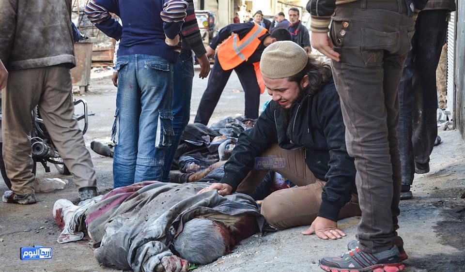 A man beside the body of a victim from the alleged Russian raid on Areeha, November 29th (via SN4HR)
