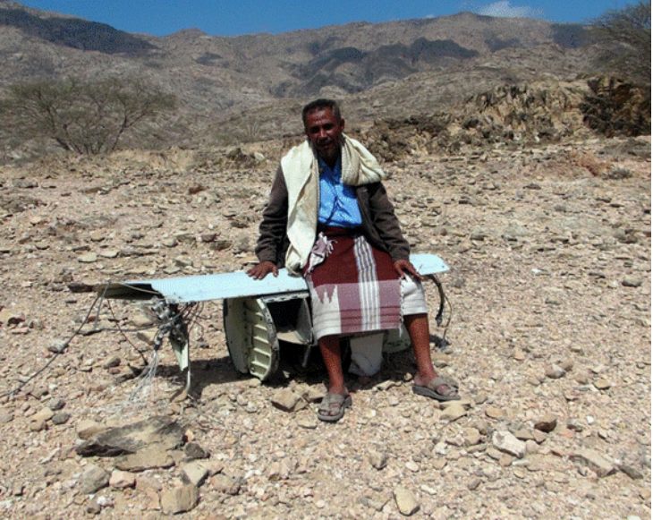 Moqbil Abu-Lukaish sits on remnants of one of the Tomahawk cruise missiles launched by the US Navy that struck al-Majalah on December 17, 2009. (via Human Rights Watch, 2012)