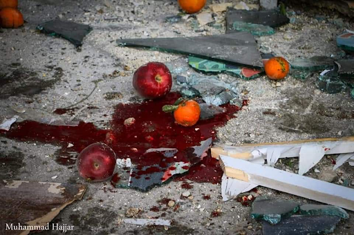 Blood covered market stalls and vegetable stands were turned over when a missile hit Al-Bab on February 2nd 2022 killing allegedly up to ten people (Image via @Gurbtwatan / Twitter)
