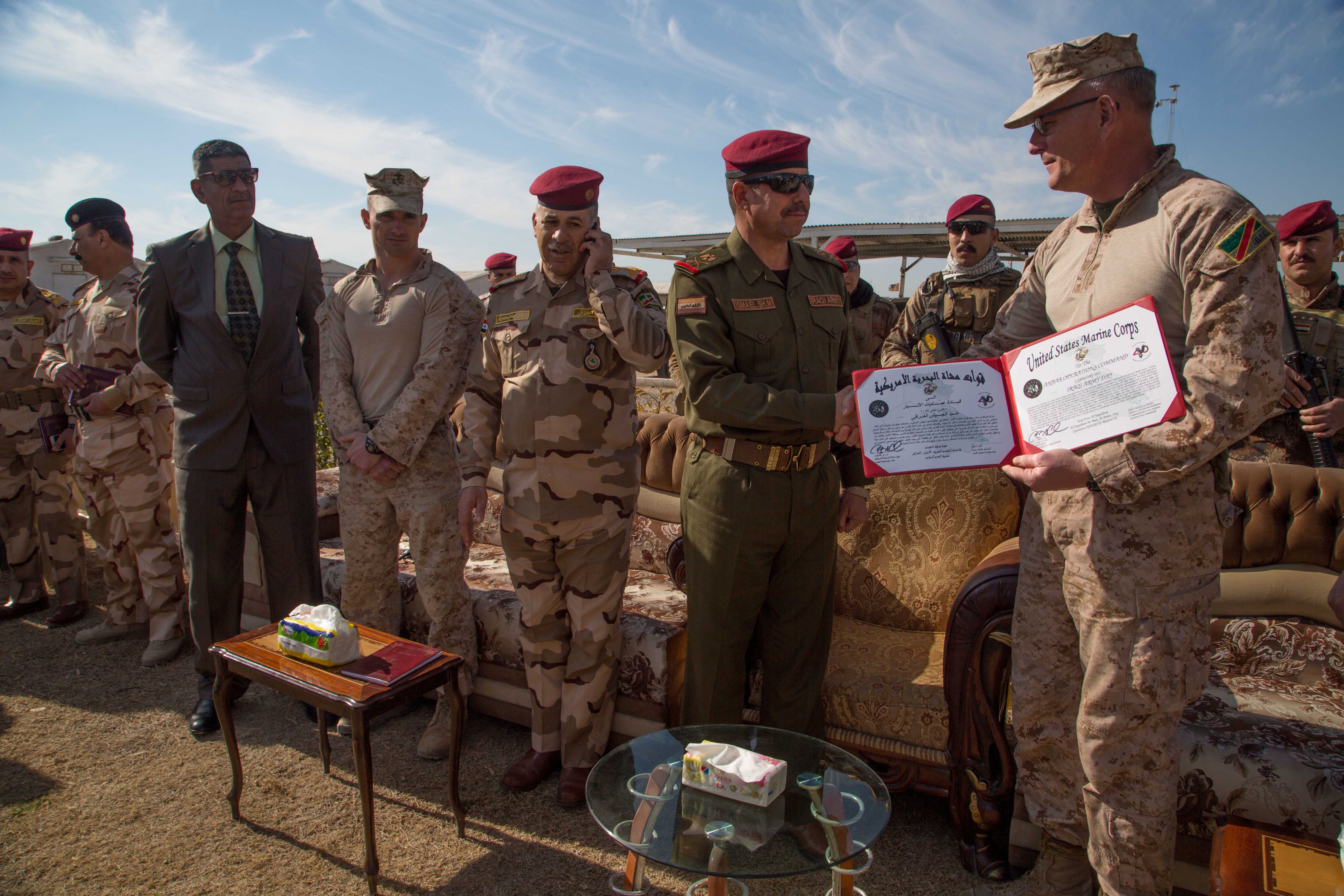 U.S. Marine Corps Col. Christian Cabaniss, Task Force Al-Taqaddum commander, awards an Iraqi security force general with a certificate of appreciation near Camp Manion, Iraq, Jan. 6, 2017. The Marines train Iraqi security forces in support of Combined Joint Task Force – Operation Inherent Resolve, the global Coalition to defeat ISIL in Iraq and Syria. (U.S. Army photo by Spc. Christopher Brecht)