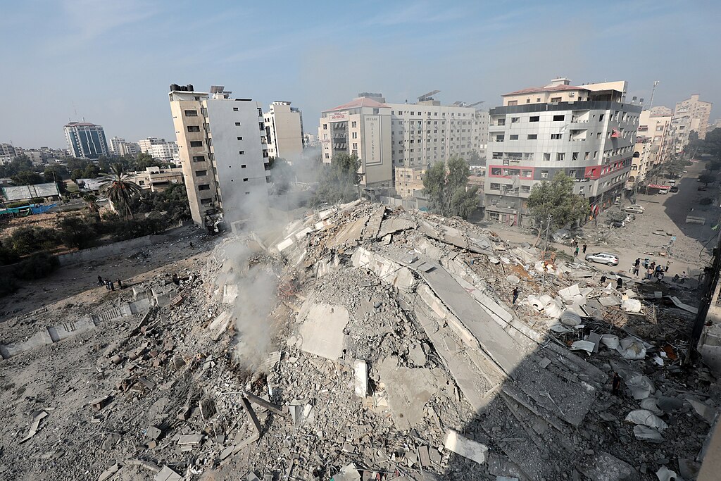Palestinians inspect the ruins of Watan Tower destroyed in Israeli airstrikes in Gaza city, on October 8, 2023 (Wafa).
